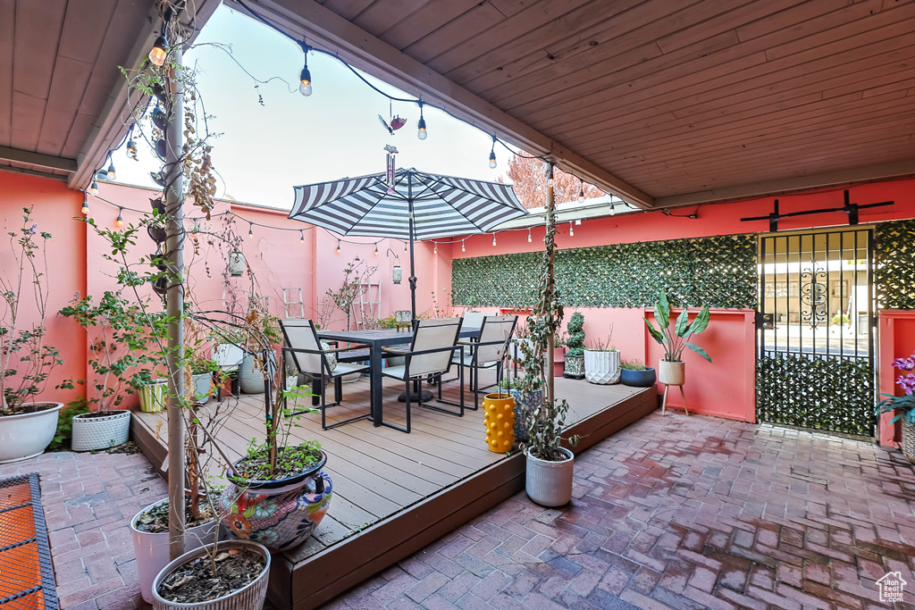Wooden deck featuring outdoor dining area and fence