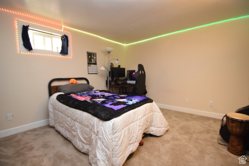 Bedroom featuring carpet flooring and baseboards