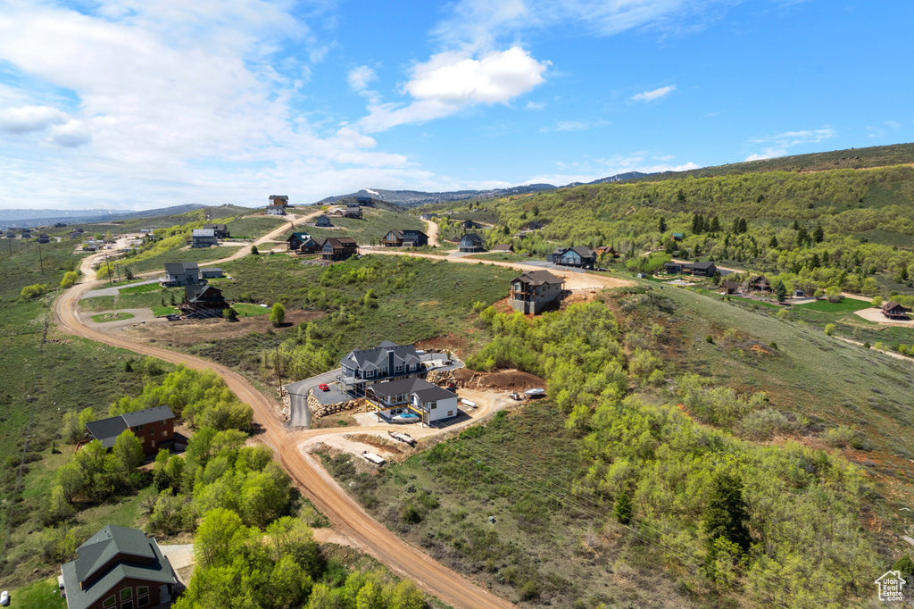 Aerial view of property and surrounding area featuring mountains