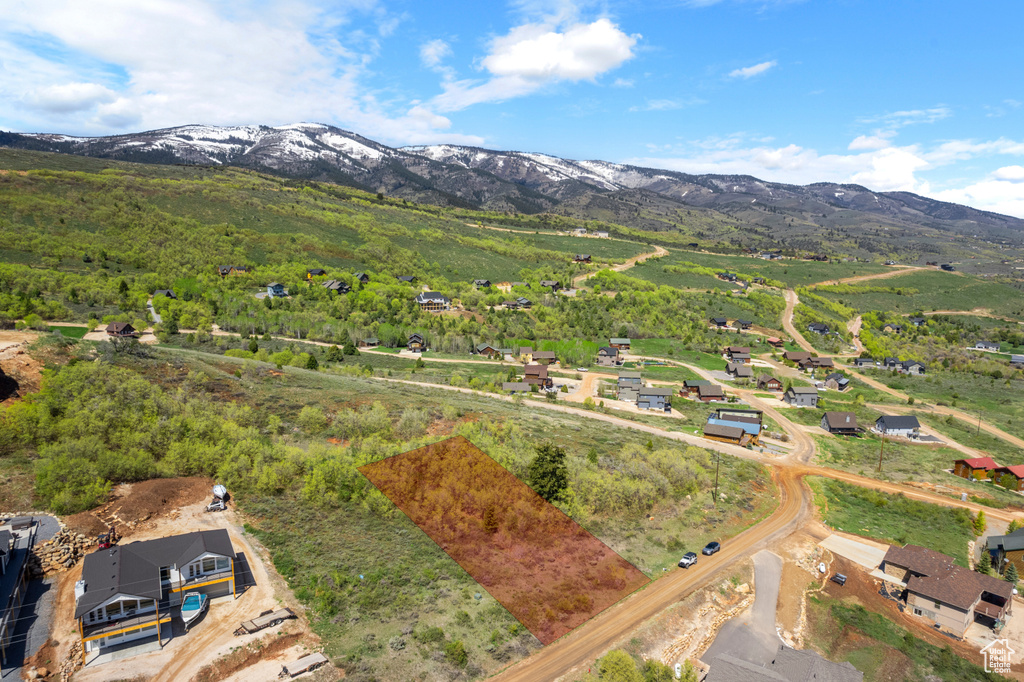 Aerial overview of property's location featuring a mountain backdrop