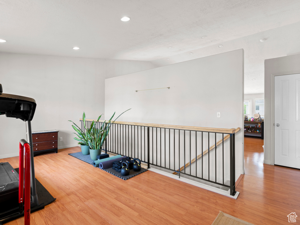 Workout room with wood finished floors, recessed lighting, and baseboards