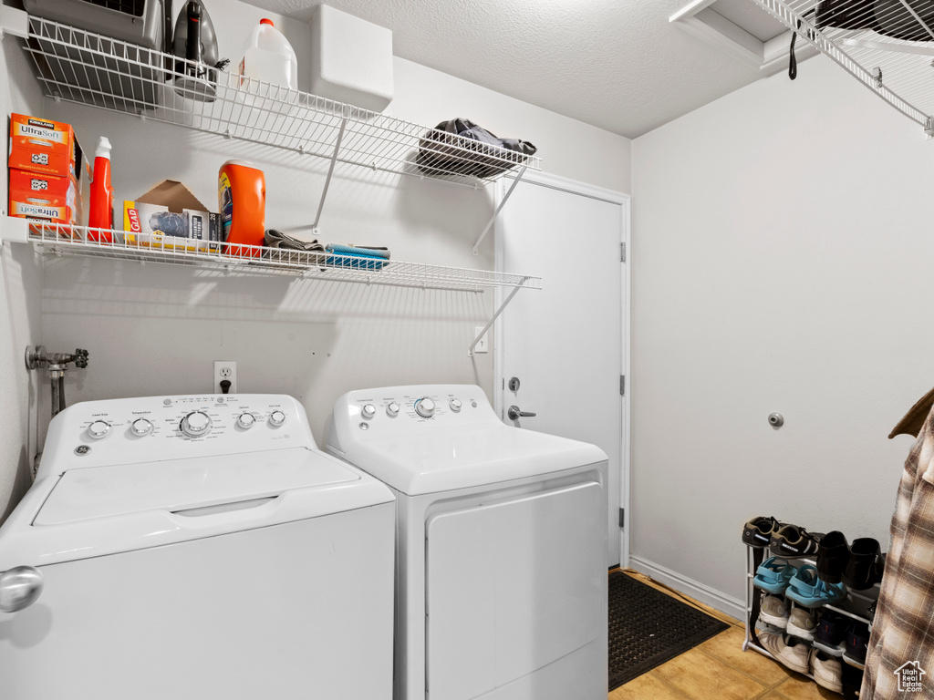 Laundry area with washing machine and clothes dryer