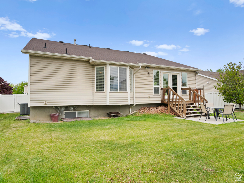 Rear view of property with cooling unit and a deck