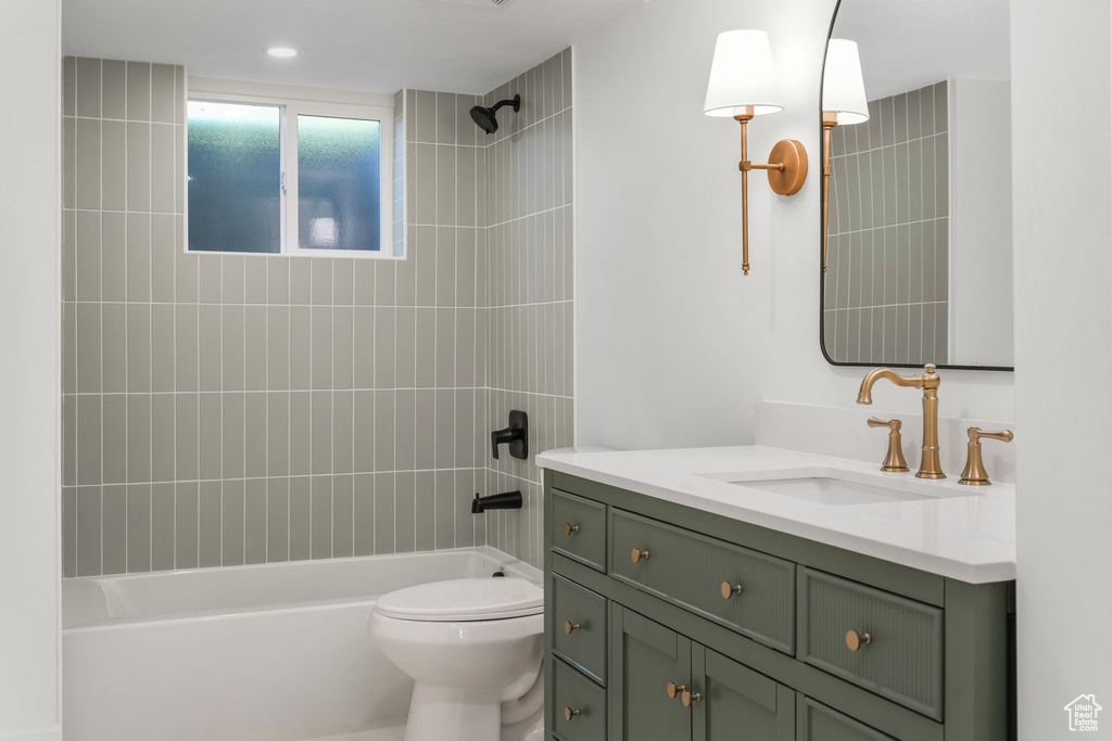 Full bathroom featuring shower / tub combination, toilet, and vanity
