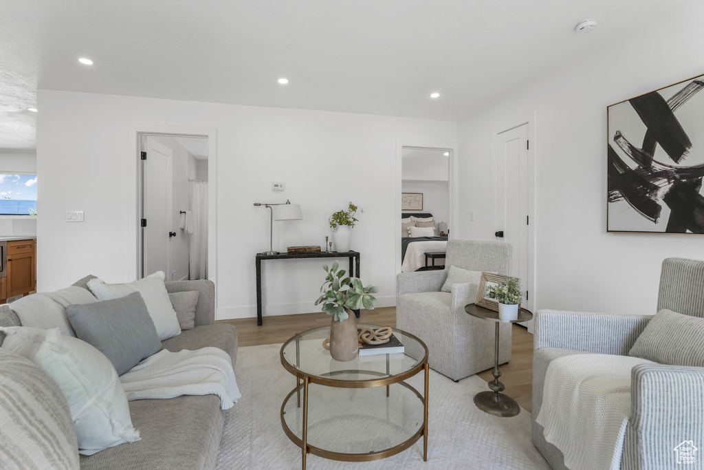 Living area featuring light wood-style flooring and recessed lighting