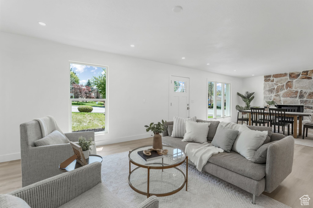 Living room featuring light wood finished floors, recessed lighting, and baseboards
