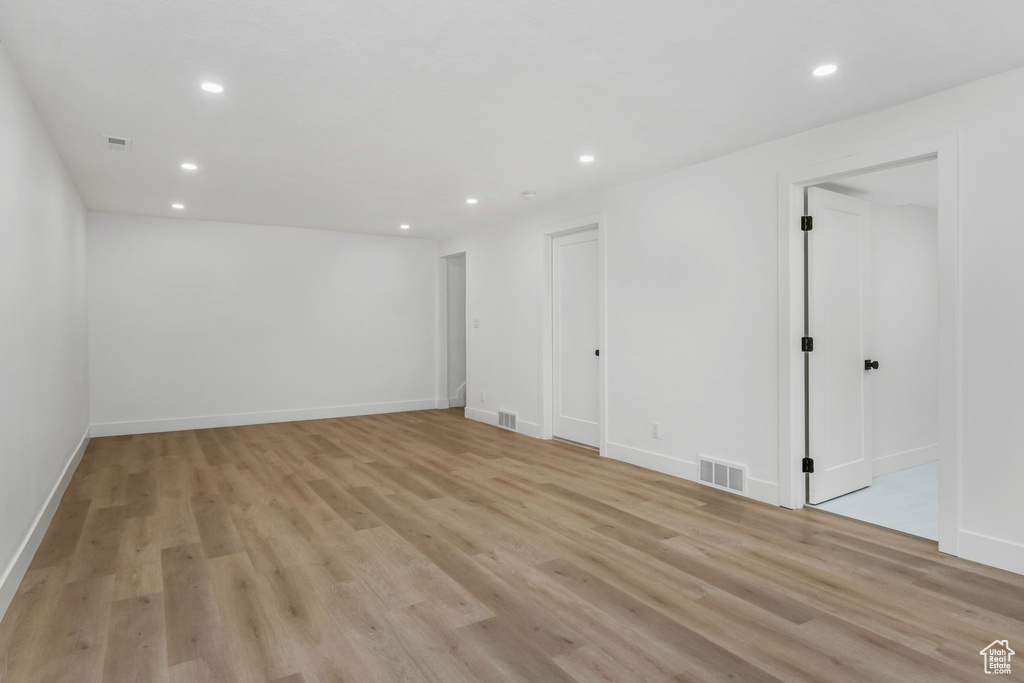 Empty room with recessed lighting, light wood-type flooring, and baseboards