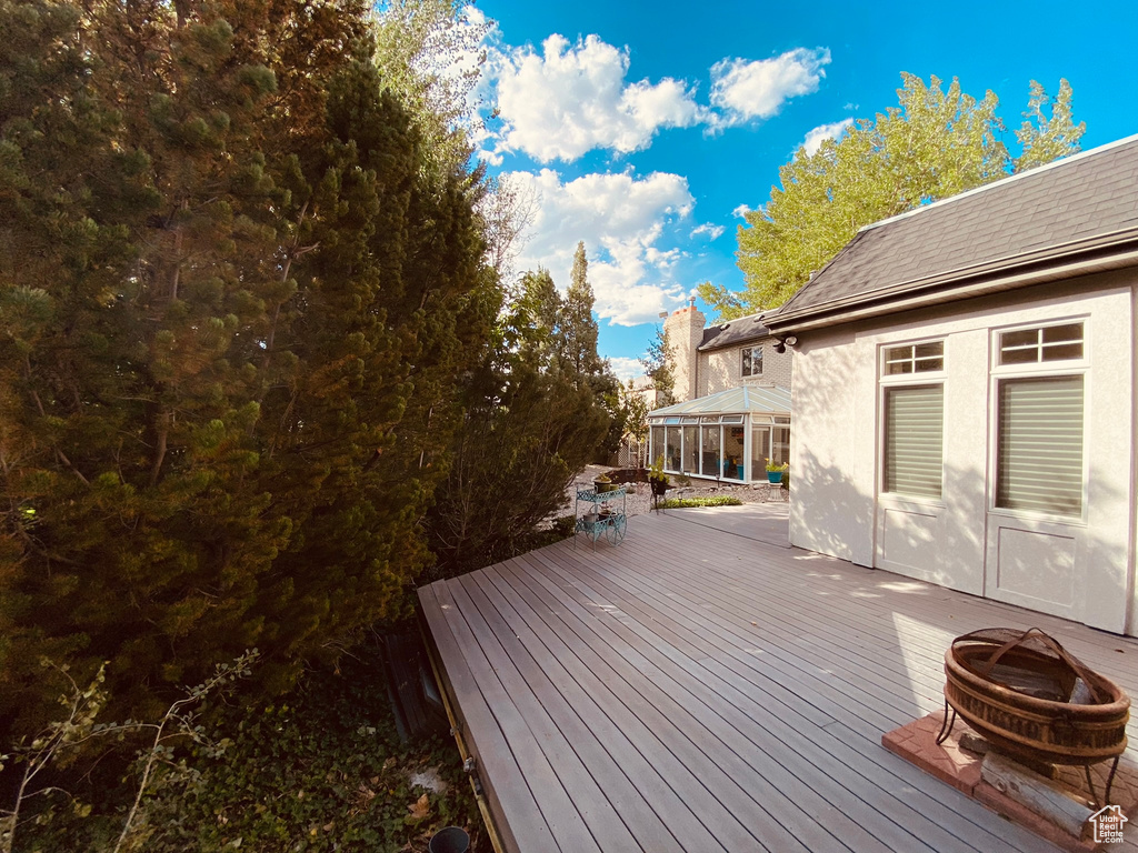 Wooden deck featuring a fire pit