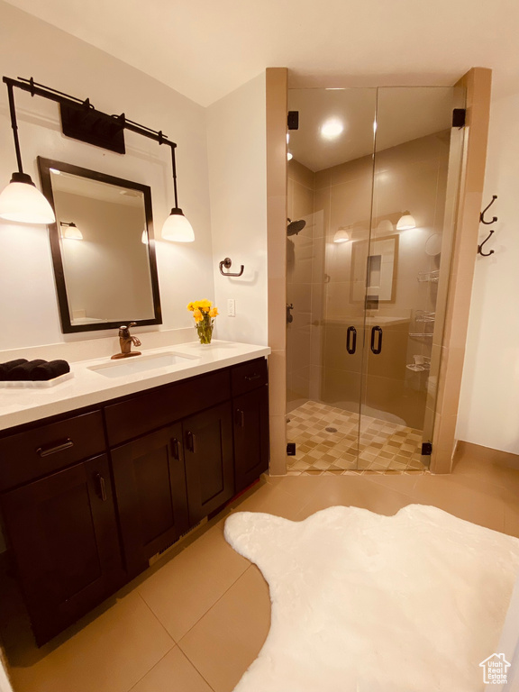 Bathroom with tile patterned floors, a stall shower, and vanity