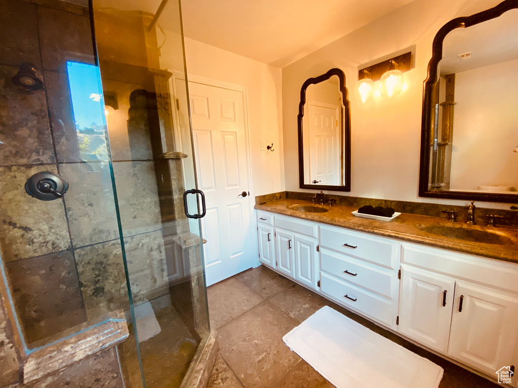 Bathroom with a stall shower and double vanity