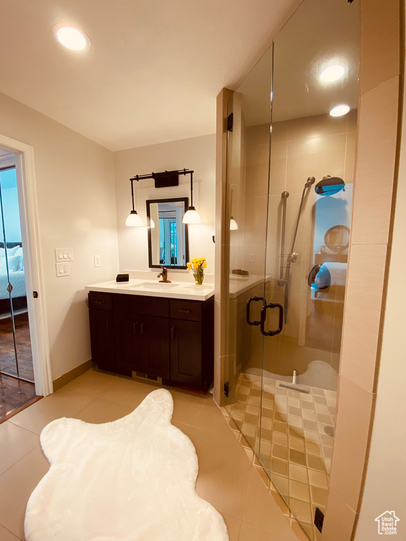 Bathroom with tile patterned flooring, a shower stall, vanity, recessed lighting, and baseboards