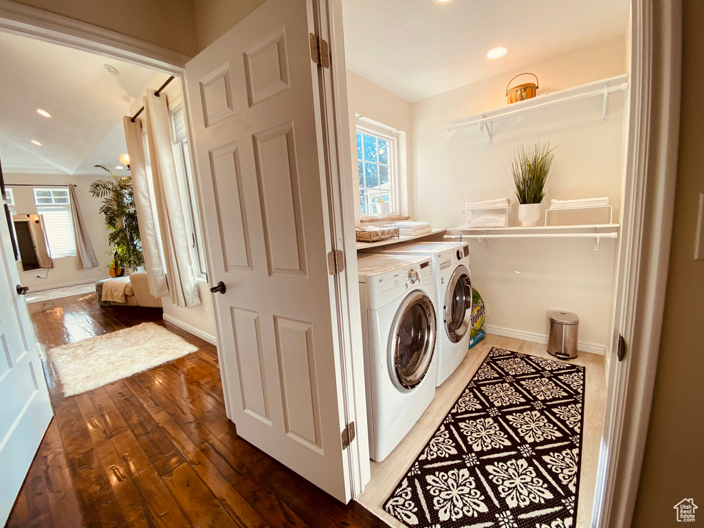 Laundry area featuring washing machine and dryer, hardwood / wood-style floors, recessed lighting, and baseboards