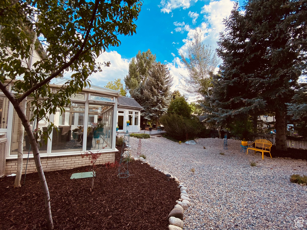 View of yard featuring a sunroom