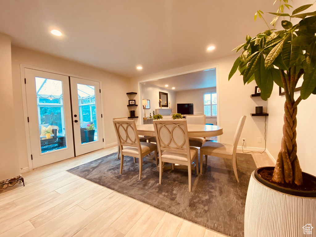 Dining room featuring french doors, wood finished floors, recessed lighting, and baseboards