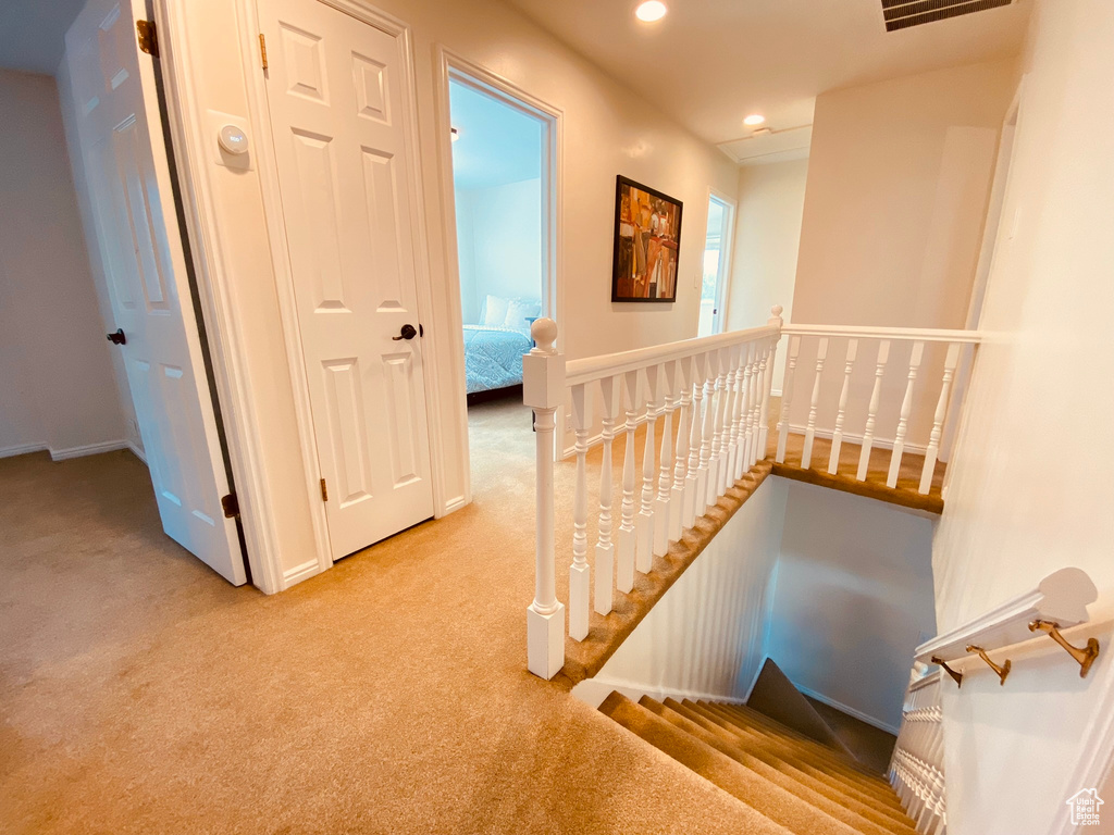 Corridor featuring an upstairs landing, carpet floors, recessed lighting, and baseboards