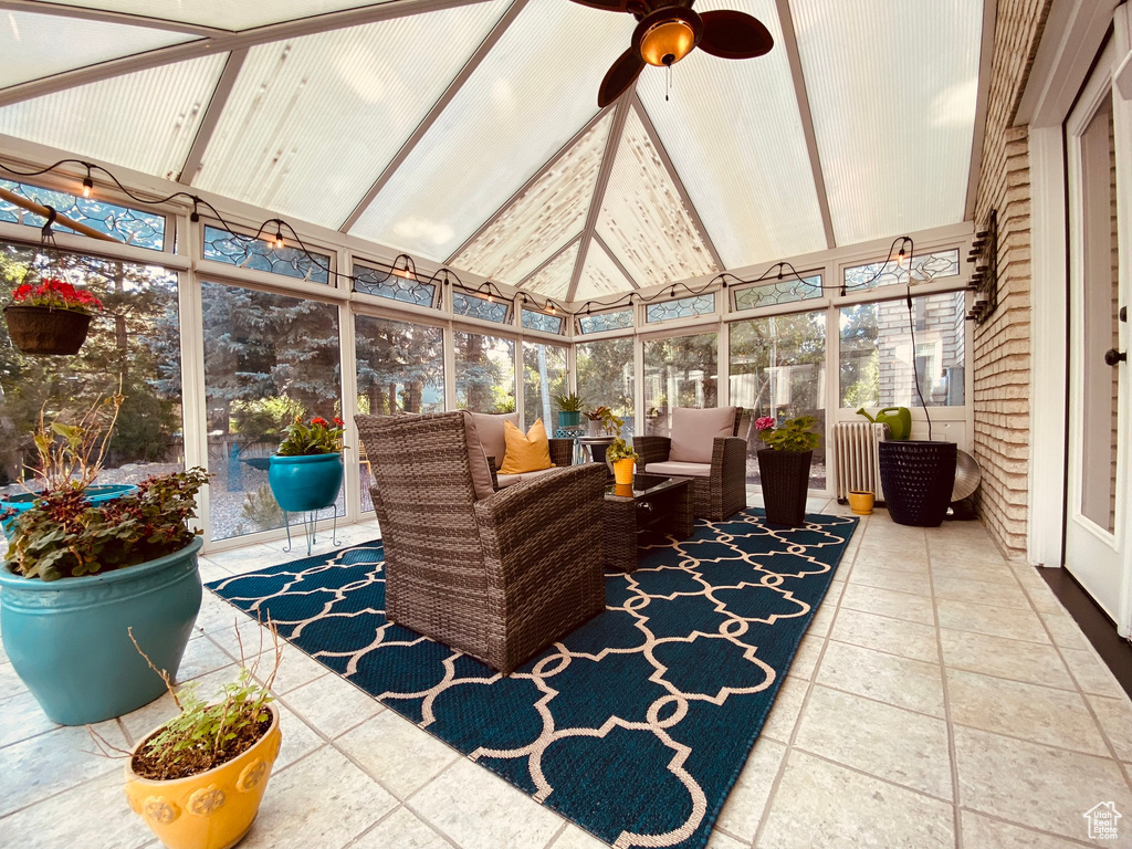 Sunroom with a ceiling fan, outdoor lounge area, and healthy amount of natural light