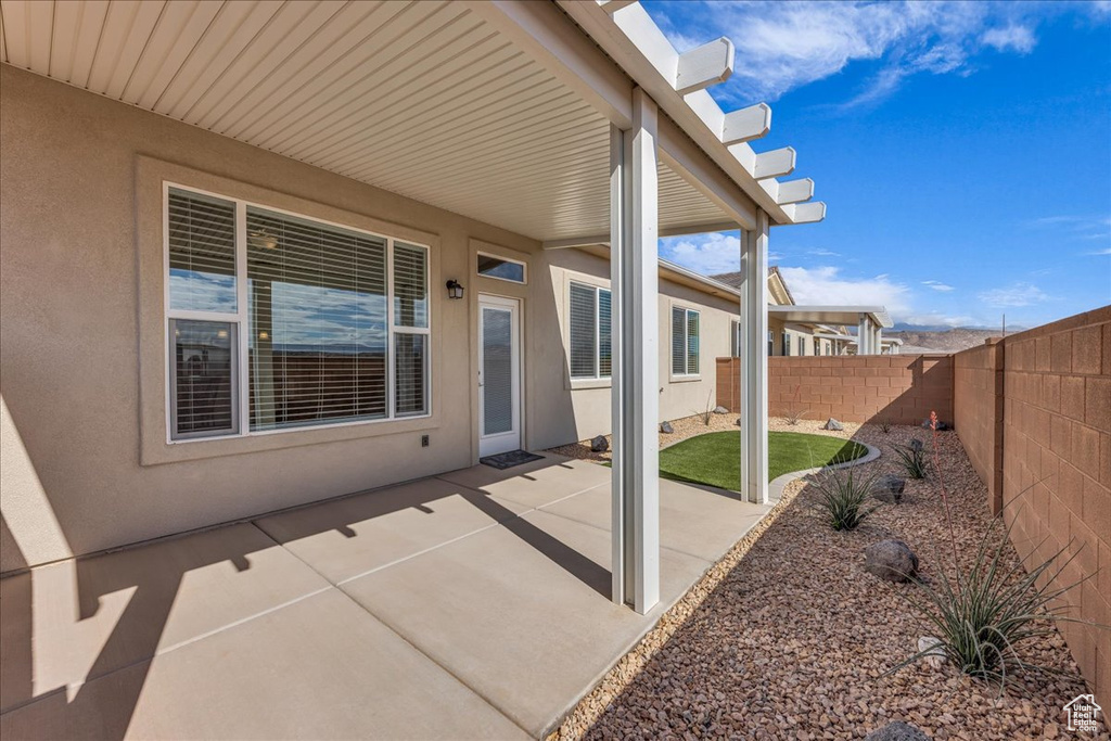 View of patio with a fenced backyard