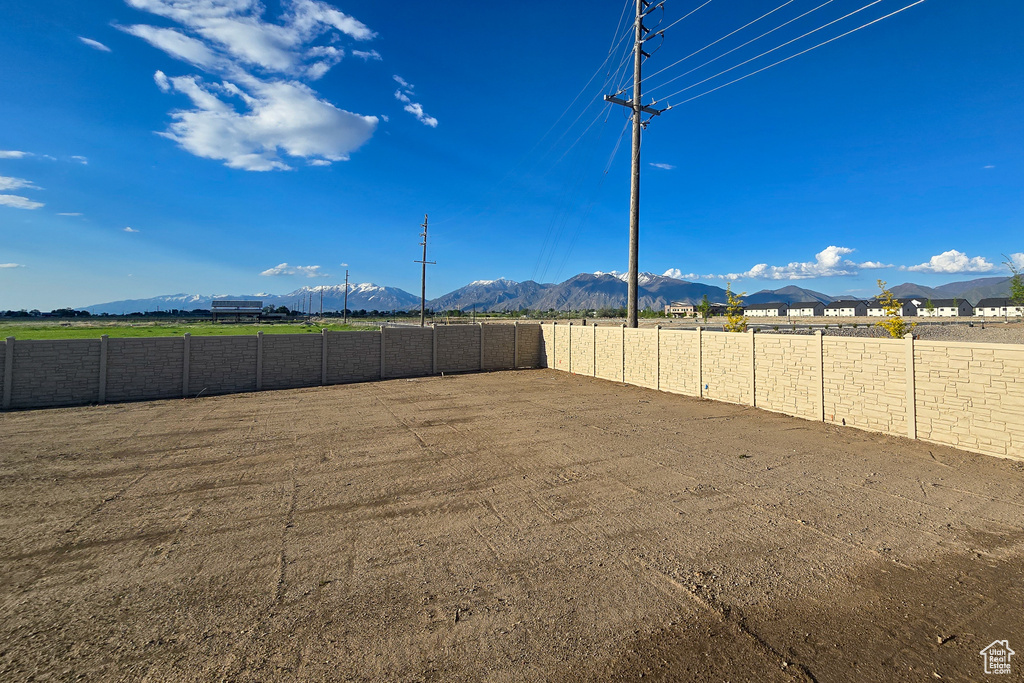 Fenced backyard featuring a mountain view