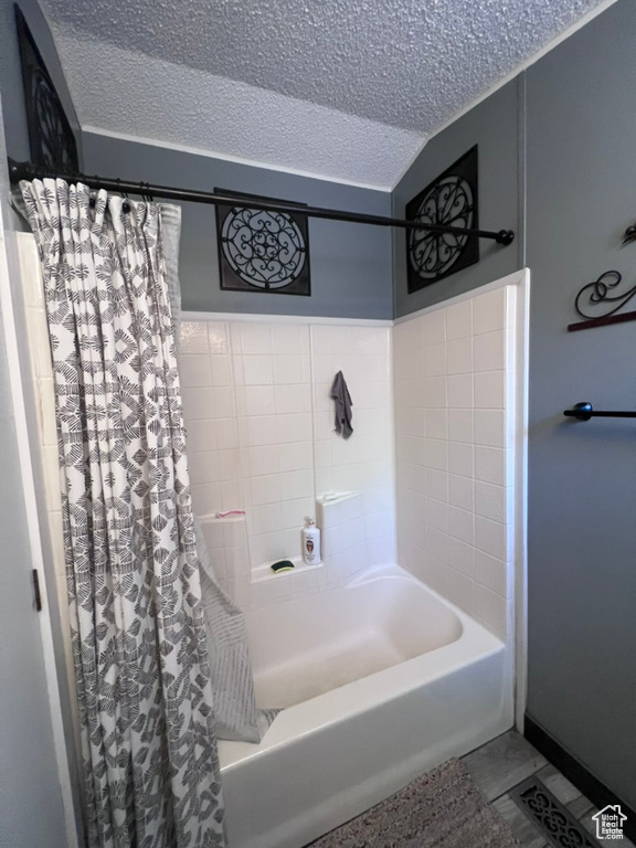 Full bath featuring a textured ceiling