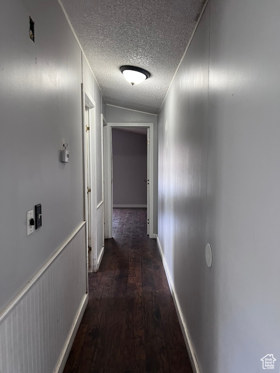 Hall featuring wood finished floors and a textured ceiling
