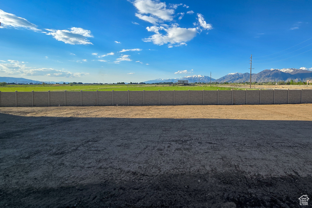 View of yard with a mountain view and an outdoor riding arena
