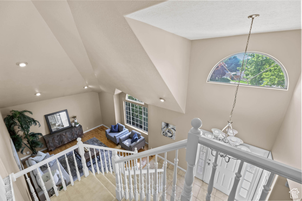 Staircase featuring vaulted ceiling, recessed lighting, and baseboards