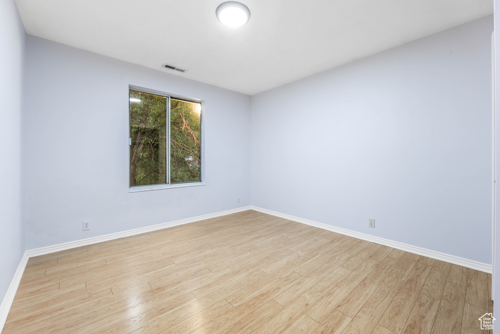 Spare room with light wood-style flooring and baseboards