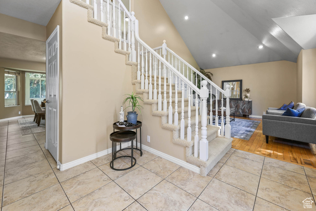 Stairway featuring tile patterned floors, baseboards, and recessed lighting