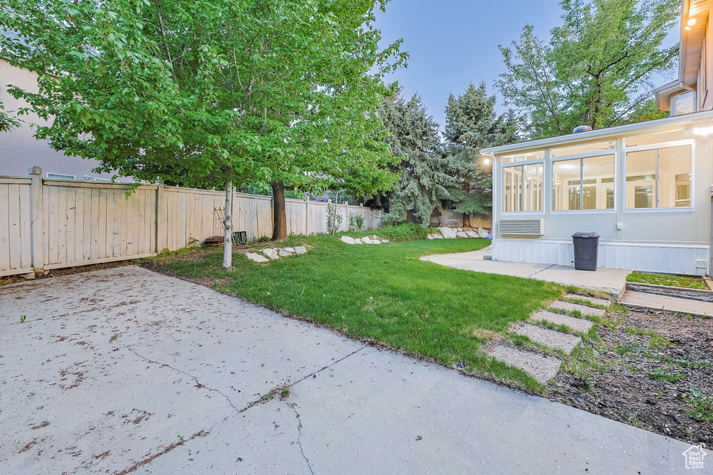View of yard with a patio and a sunroom