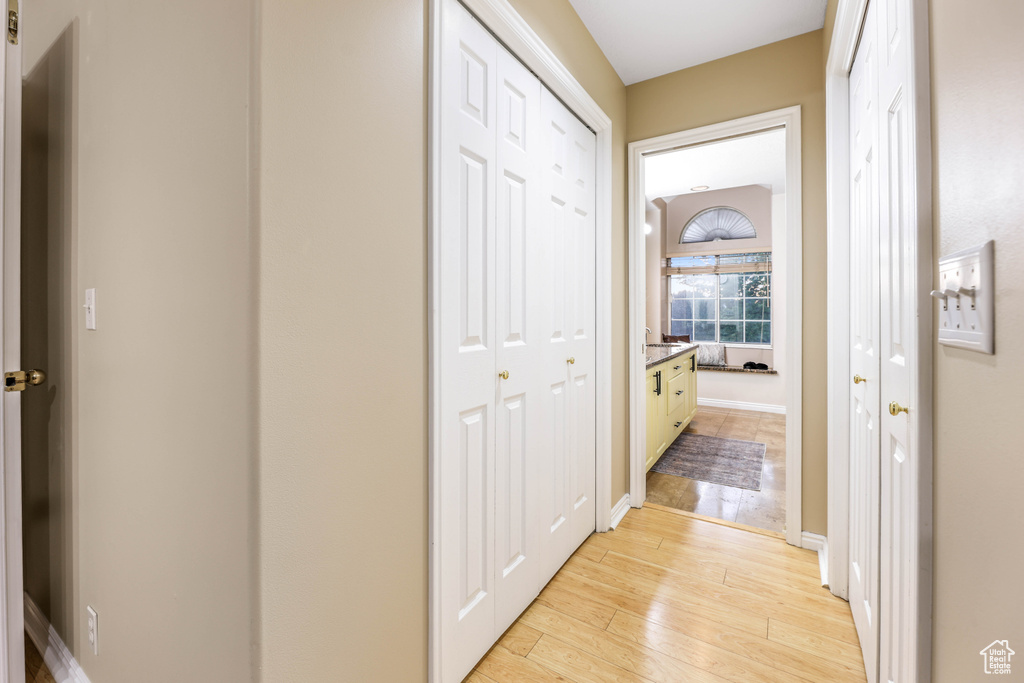 Hall featuring light wood finished floors and baseboards