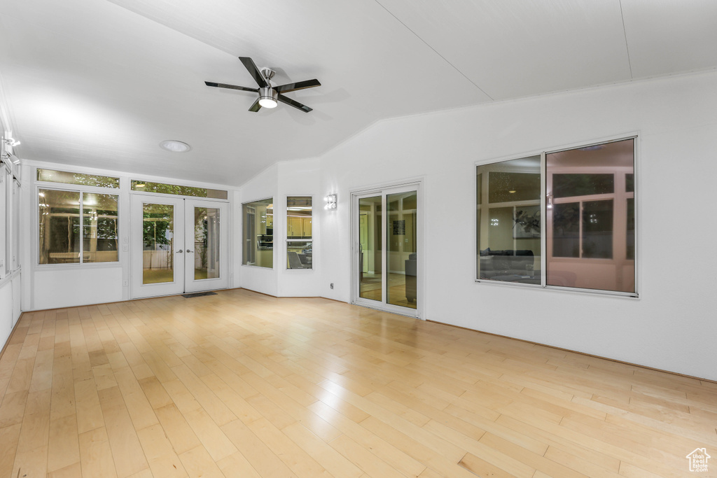 Unfurnished sunroom with french doors and lofted ceiling
