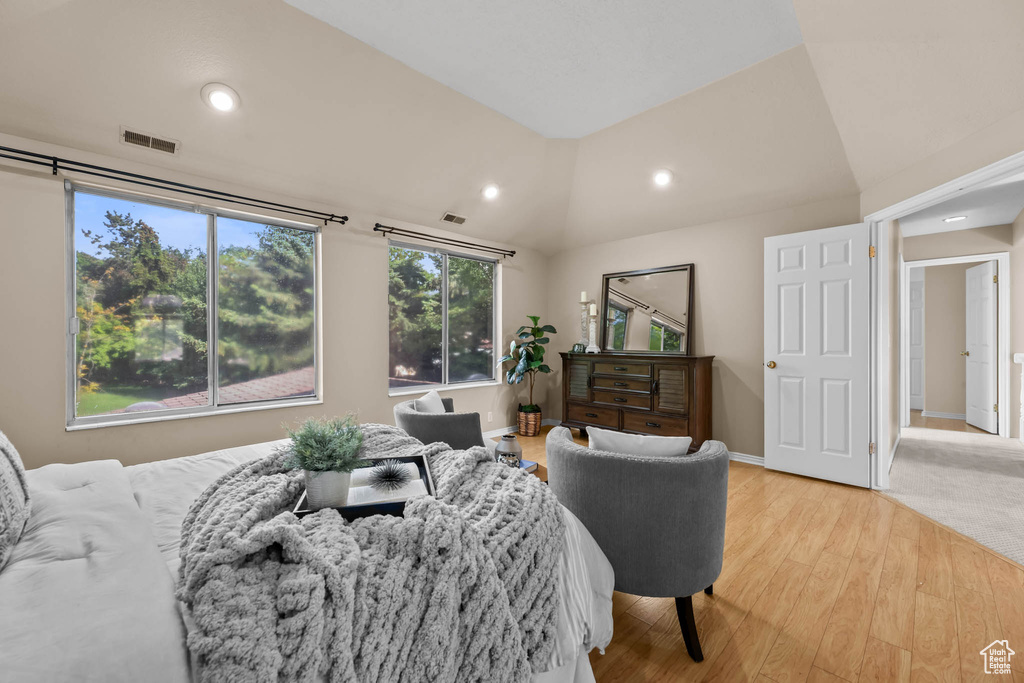 Bedroom featuring light wood finished floors, vaulted ceiling, recessed lighting, and baseboards