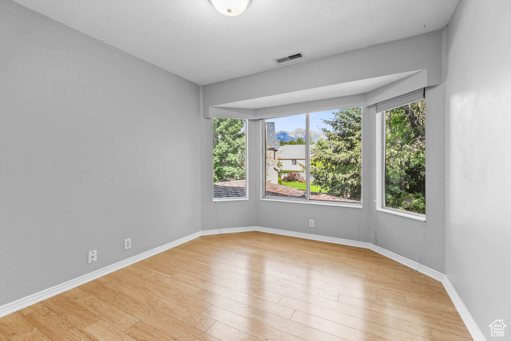 Empty room featuring wood finished floors and baseboards