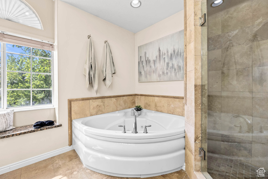 Full bath with a stall shower, a jetted tub, baseboards, and recessed lighting