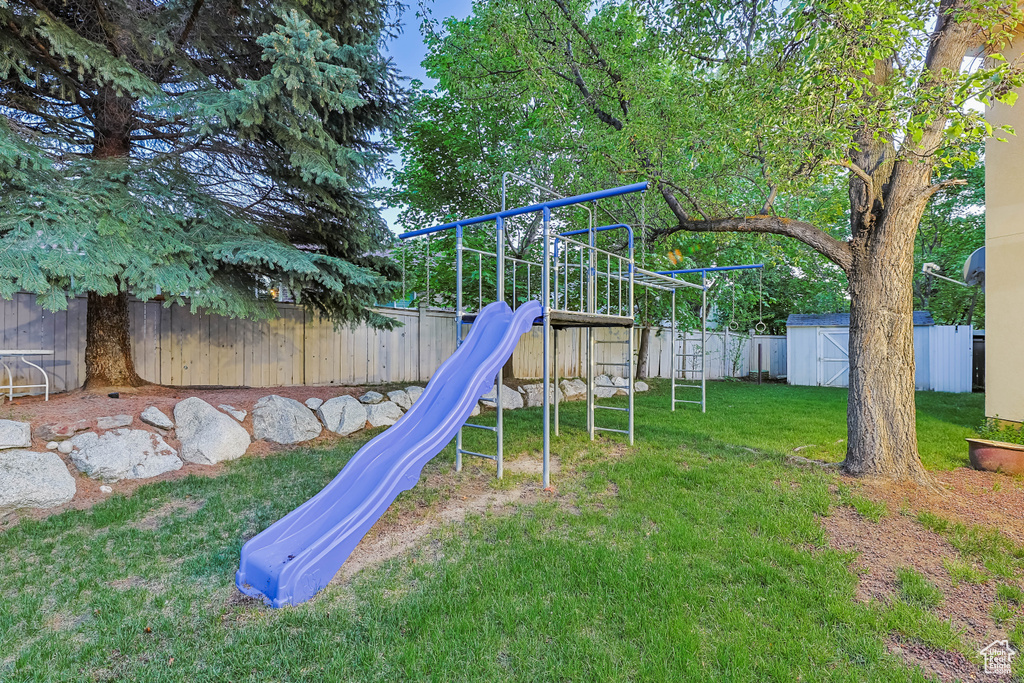 View of play area featuring a storage unit and an outbuilding