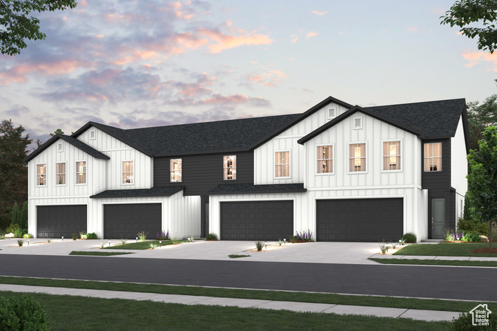 Modern farmhouse featuring an attached garage, board and batten siding, driveway, and roof with shingles