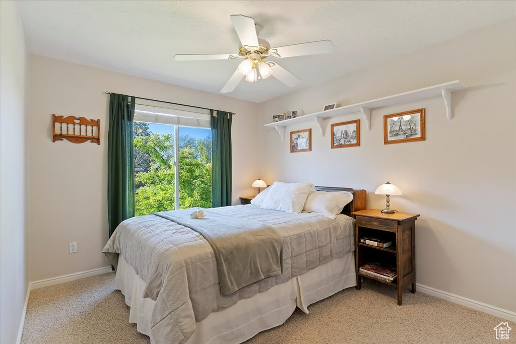Bedroom with carpet floors, baseboards, and a ceiling fan