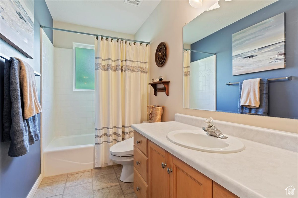 Bathroom featuring vanity, toilet, and shower / bath combo