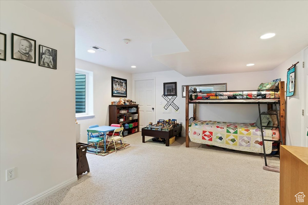 Carpeted bedroom with recessed lighting and baseboards