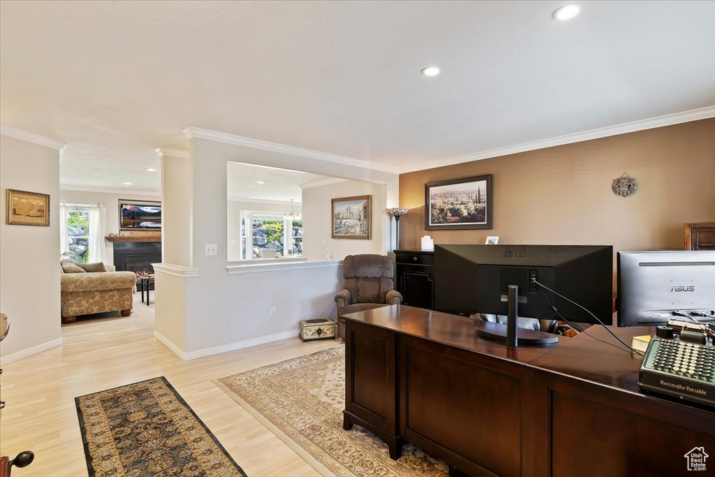 Office area with healthy amount of natural light, light wood-style floors, ornamental molding, baseboards, and recessed lighting