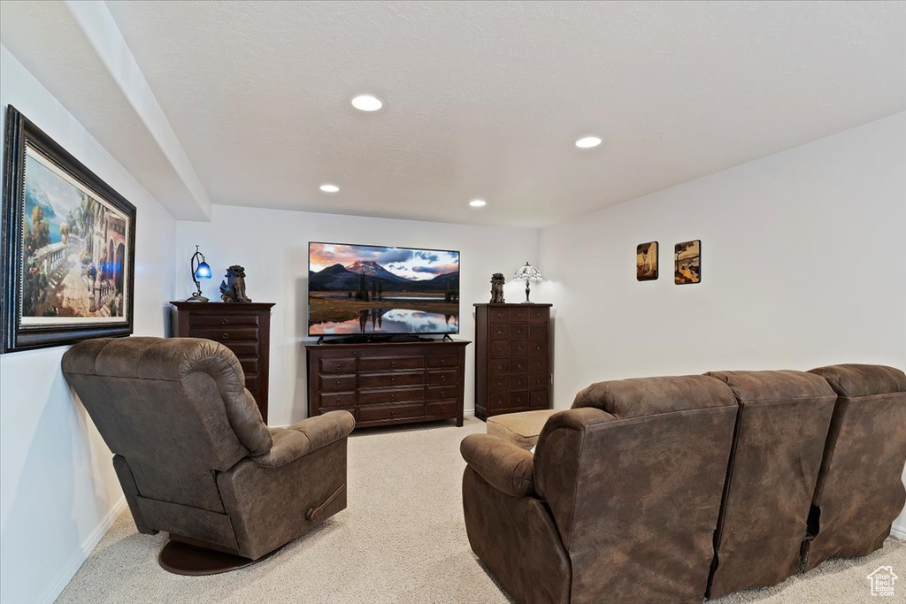 Living area with carpet flooring, recessed lighting, and baseboards