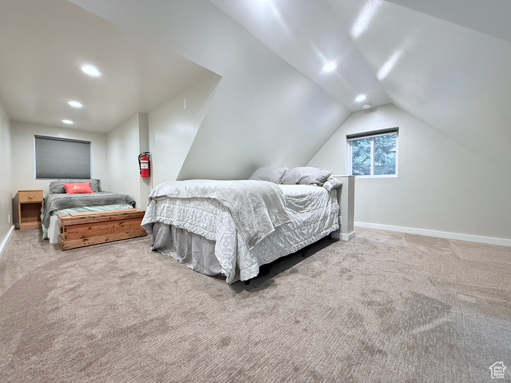 Carpeted bedroom featuring recessed lighting, lofted ceiling, and baseboards