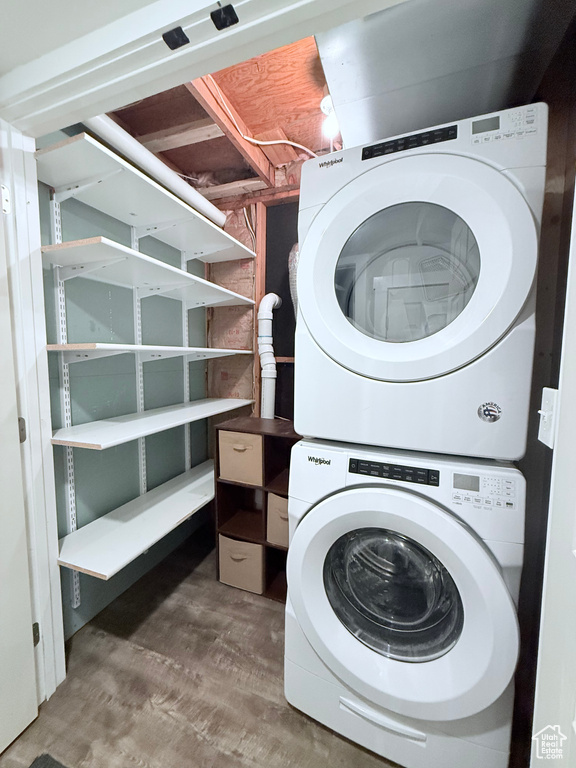Laundry area featuring stacked washer / drying machine