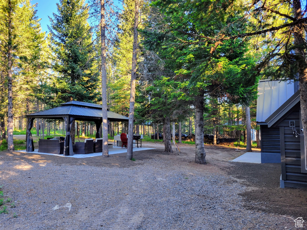 View of home's community featuring a gazebo, an outdoor living space, and a patio