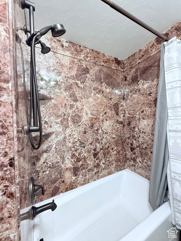 Full bath with shower / bath combination with curtain