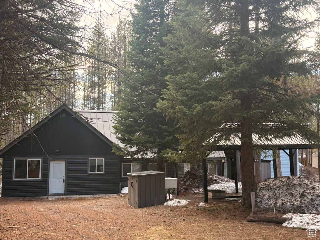View of side of home featuring metal roof