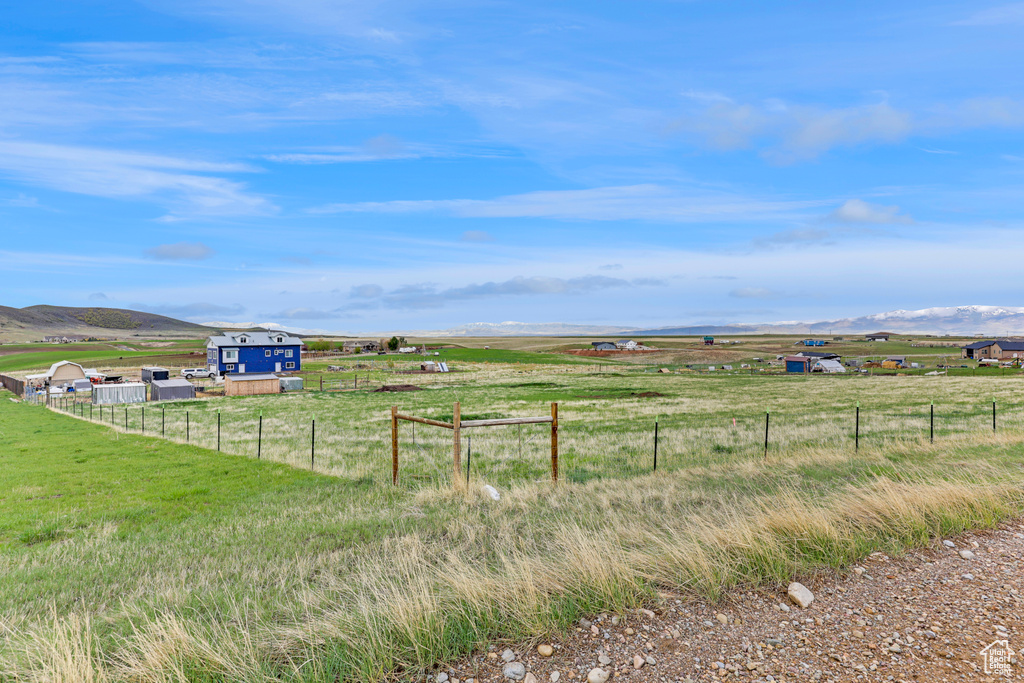 View of yard with a view of countryside and fence