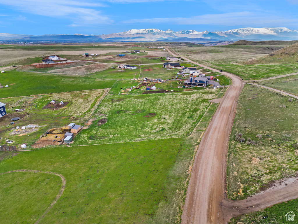 Aerial view of property's location featuring a mountainous background