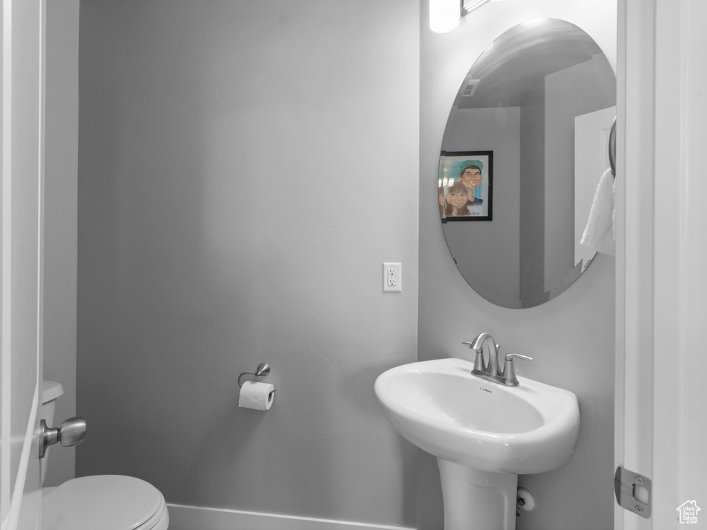 Half bath with toilet and a sink