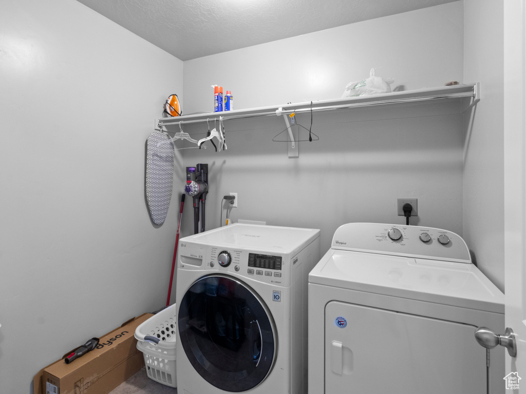 Clothes washing area with washing machine and dryer and a textured ceiling
